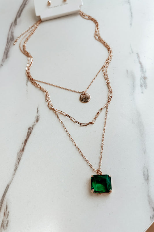 layered gold and emerald charm necklace set